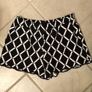 black and white patterned scallop shorts.